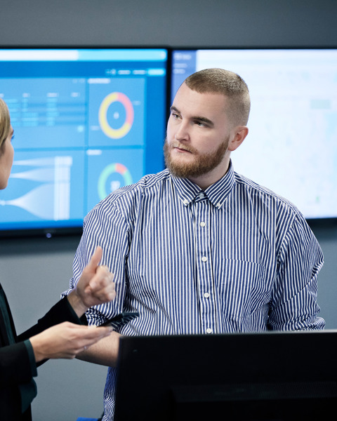 Two IT specialists talking inside the Danoffice IT office.